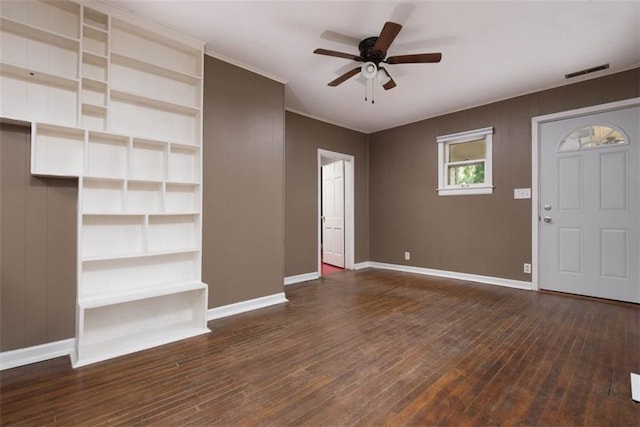 interior space with baseboards, wood-type flooring, visible vents, and a ceiling fan