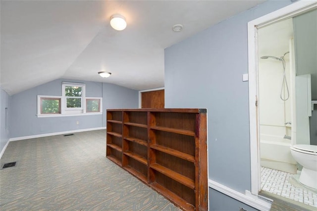 bonus room featuring lofted ceiling, carpet floors, visible vents, and baseboards