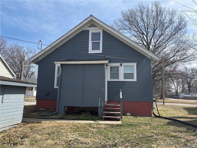 back of property with a lawn