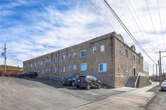 view of building exterior with uncovered parking