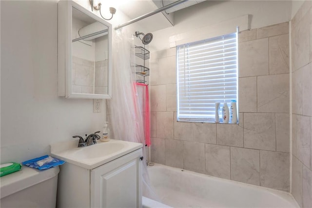 bathroom with toilet, shower / bath combo, and vanity