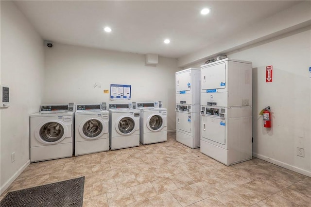 common laundry area featuring baseboards, washer and dryer, stacked washer / dryer, and recessed lighting