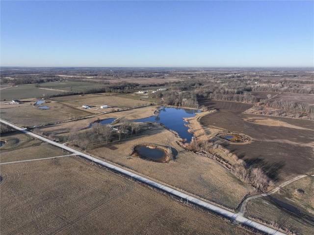 birds eye view of property featuring a rural view and a water view