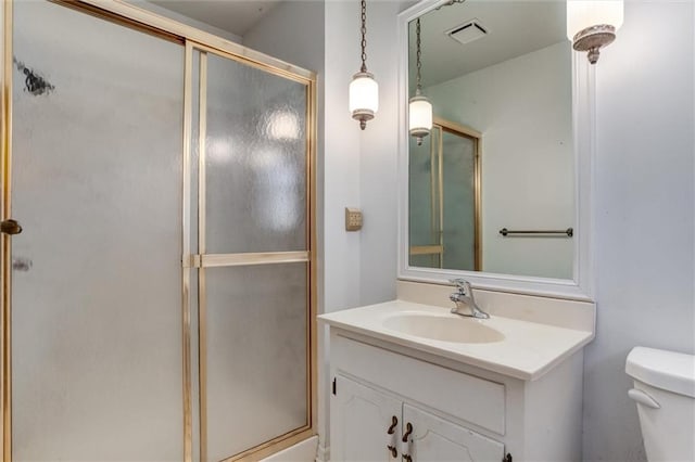 full bathroom with visible vents, a shower stall, toilet, and vanity