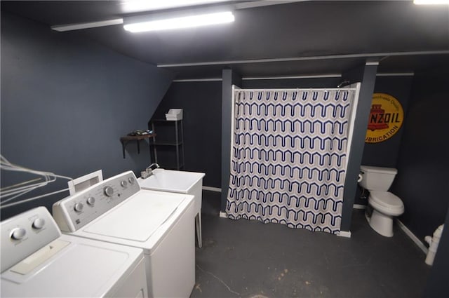 laundry room with laundry area, baseboards, washer and clothes dryer, and a sink