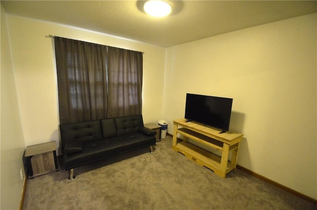 sitting room featuring carpet flooring and baseboards