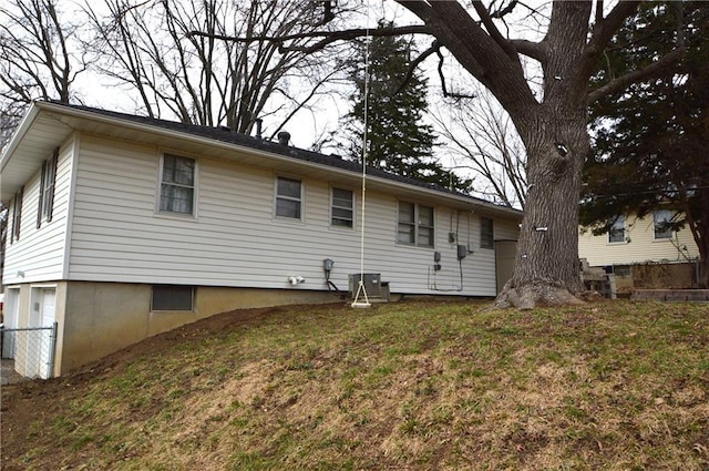 rear view of property featuring a lawn