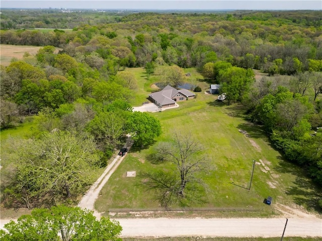 drone / aerial view with a view of trees and a rural view