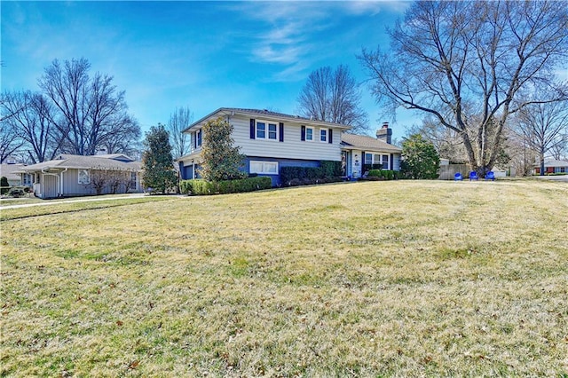 tri-level home with a garage and a front yard