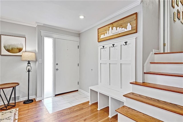 foyer featuring visible vents, ornamental molding, recessed lighting, stairway, and baseboards