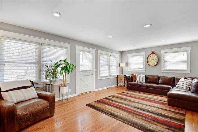 living area with recessed lighting, light wood-type flooring, and baseboards