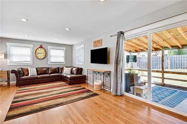 living area featuring recessed lighting, baseboards, and wood finished floors