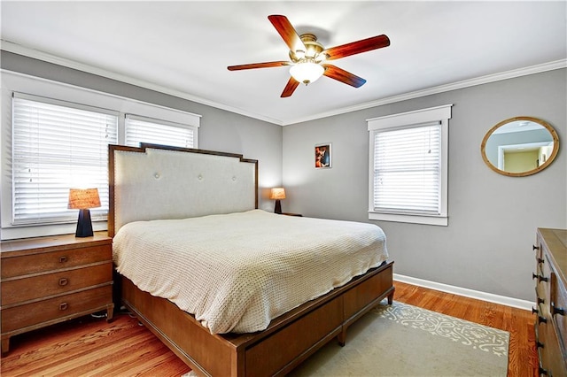 bedroom featuring light wood finished floors, multiple windows, and crown molding