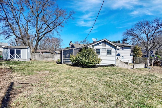 exterior space with a lawn, a storage shed, an outdoor structure, and fence