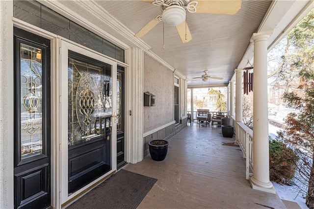 view of exterior entry with covered porch and a ceiling fan