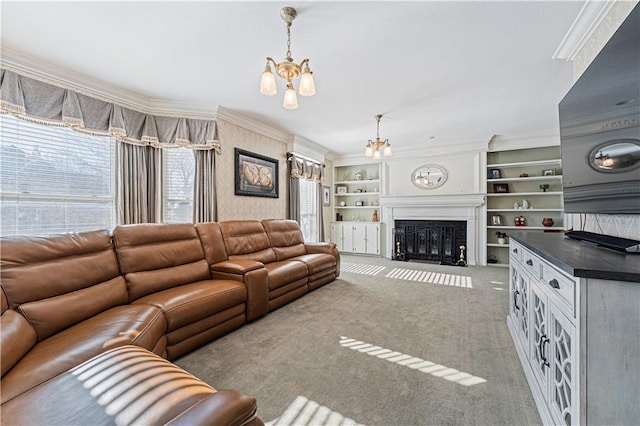 living room with built in shelves, crown molding, a fireplace with flush hearth, carpet floors, and a notable chandelier