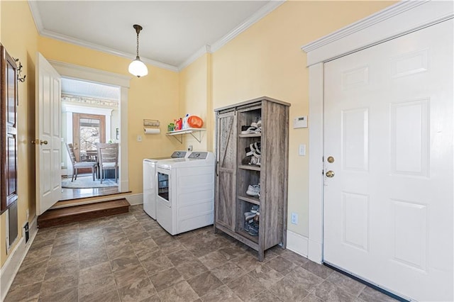 laundry room with baseboards, crown molding, laundry area, and washer and clothes dryer