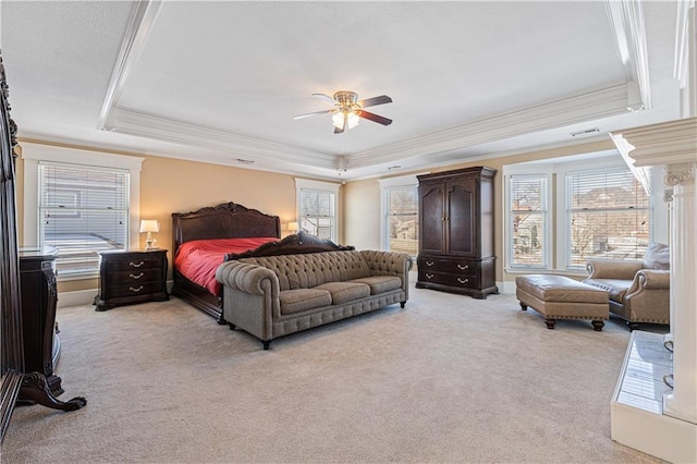 bedroom featuring light carpet, a tray ceiling, and ornamental molding