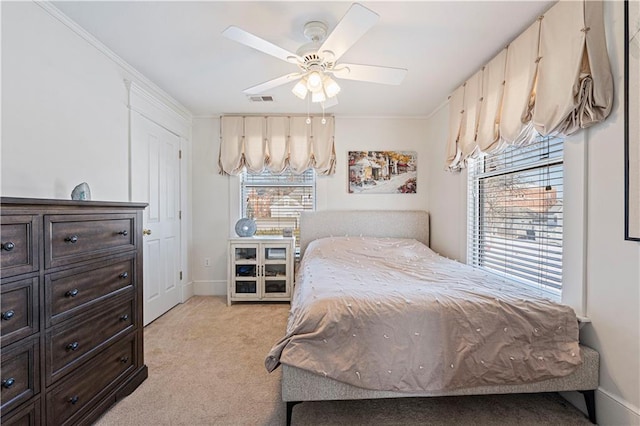 bedroom with visible vents, light carpet, multiple windows, and baseboards