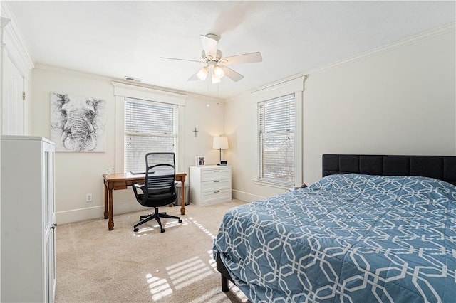 carpeted bedroom with visible vents, baseboards, ceiling fan, and crown molding