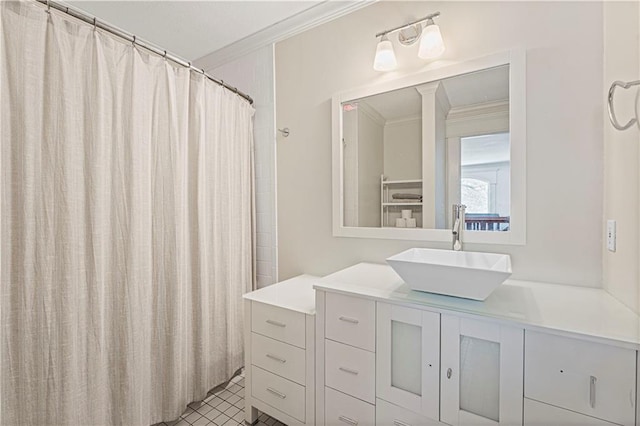 bathroom with tile patterned floors, vanity, and crown molding