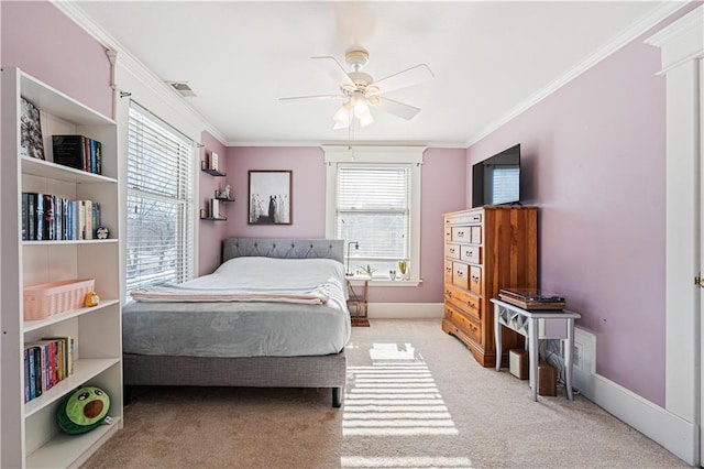 carpeted bedroom featuring visible vents, a ceiling fan, baseboards, and ornamental molding