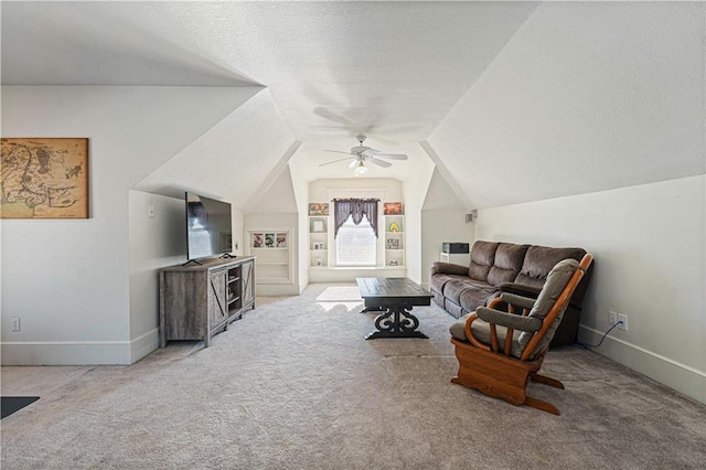 carpeted living room with built in features, baseboards, a textured ceiling, and vaulted ceiling