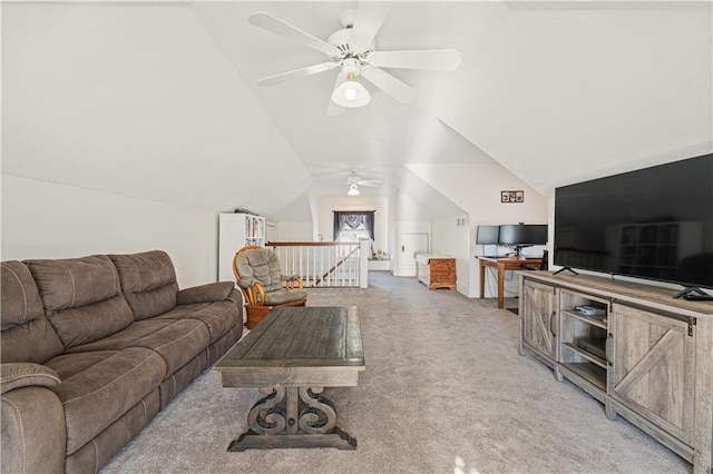 living area featuring light colored carpet, ceiling fan, and vaulted ceiling