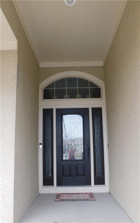 doorway to property with stucco siding