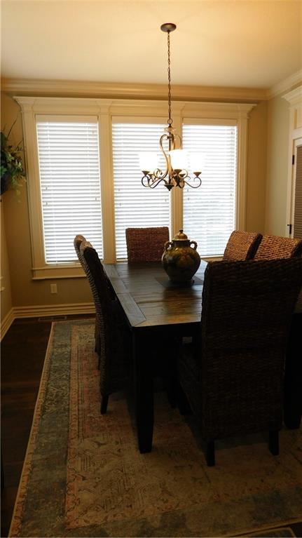 dining area with plenty of natural light, baseboards, and an inviting chandelier