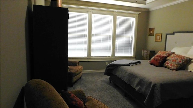 carpeted bedroom featuring baseboards and ornamental molding