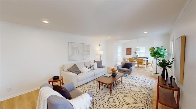 living room featuring ornamental molding, recessed lighting, wood finished floors, and baseboards