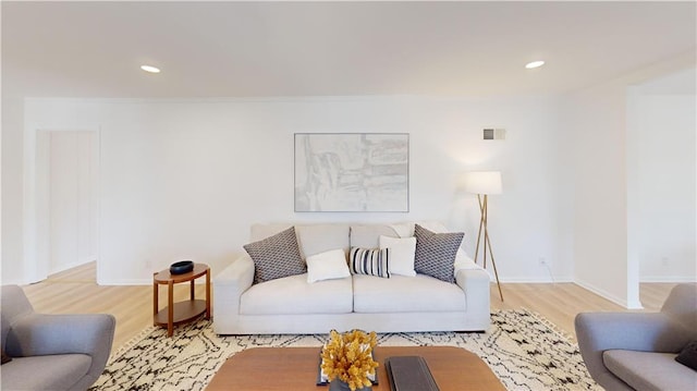 living room with recessed lighting, baseboards, and wood finished floors