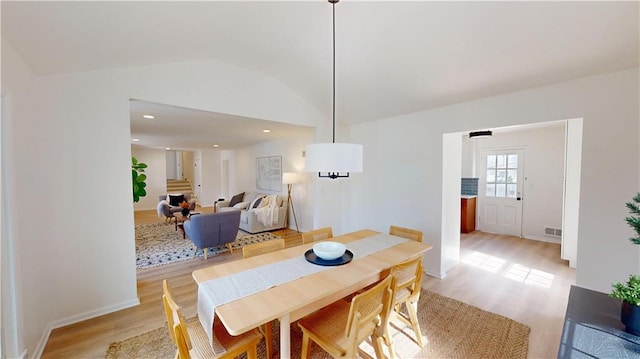 dining room with vaulted ceiling, light wood finished floors, visible vents, and recessed lighting