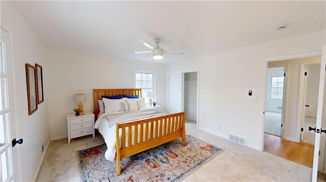 bedroom with a closet, visible vents, ceiling fan, and baseboards