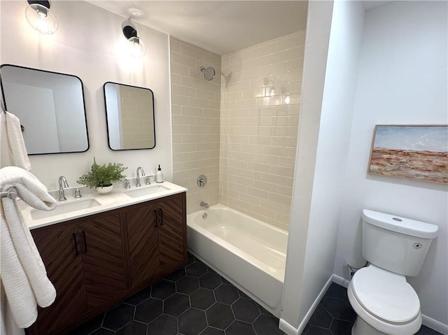 full bathroom with washtub / shower combination, a sink, toilet, and tile patterned floors