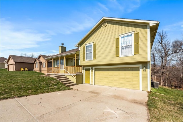 tri-level home with central AC unit, driveway, covered porch, a chimney, and a front lawn