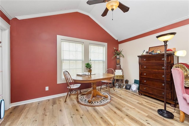 dining space with baseboards, vaulted ceiling, ornamental molding, wood finished floors, and a ceiling fan