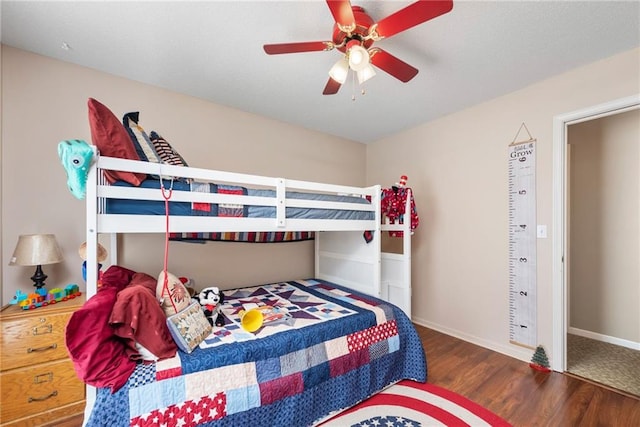 bedroom with baseboards, ceiling fan, and wood finished floors