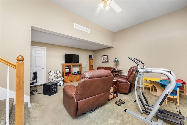 living area with visible vents, carpet flooring, stairway, and a ceiling fan