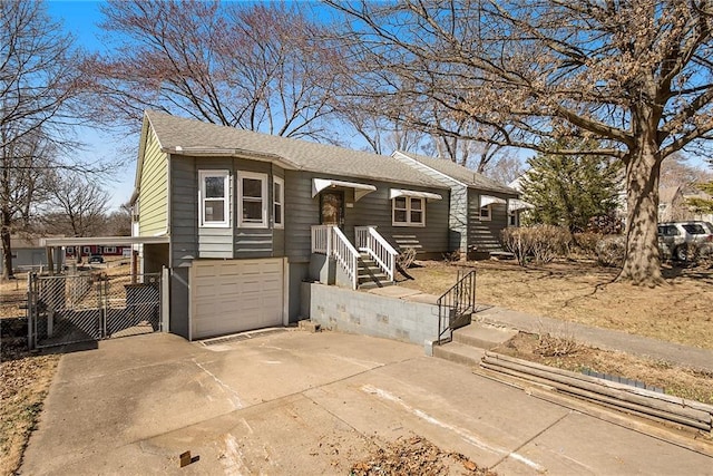 view of front of property with fence, roof with shingles, driveway, an attached garage, and a gate