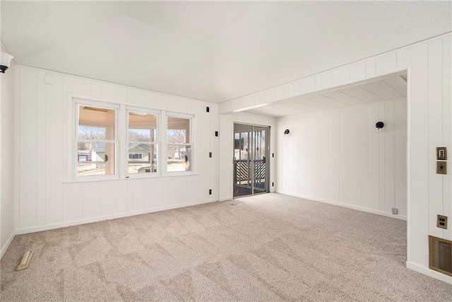 carpeted spare room featuring baseboards and visible vents