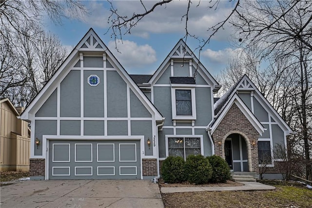 view of front of house with concrete driveway, brick siding, and stucco siding