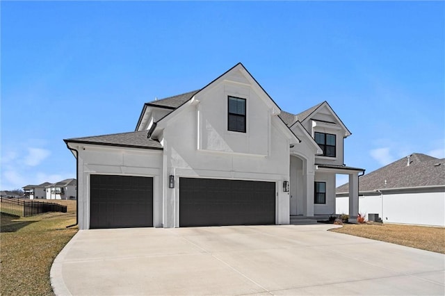 modern farmhouse style home featuring fence, an attached garage, a shingled roof, stucco siding, and concrete driveway