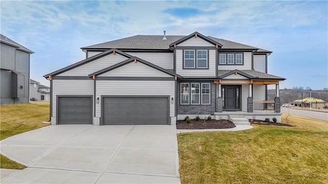 view of front facade featuring a garage, driveway, and a front lawn