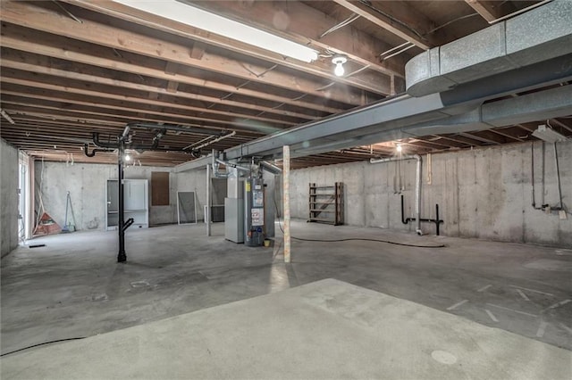 unfinished basement featuring water heater