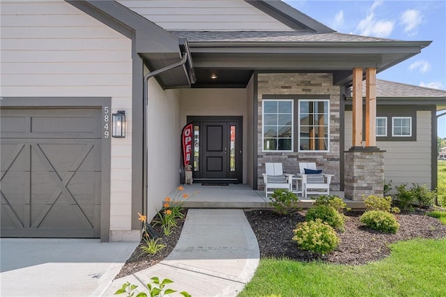 property entrance featuring a garage, stone siding, covered porch, and a shingled roof