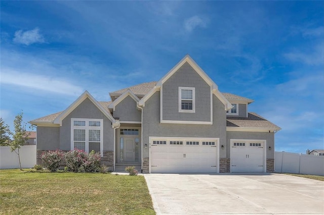 craftsman inspired home featuring an attached garage, stone siding, and fence