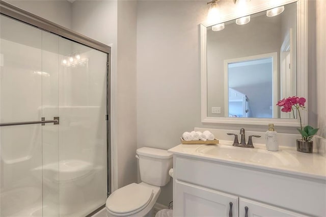 full bathroom featuring toilet, a shower stall, and vanity