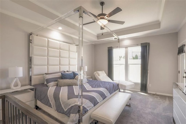 bedroom with carpet floors, a ceiling fan, baseboards, a tray ceiling, and crown molding